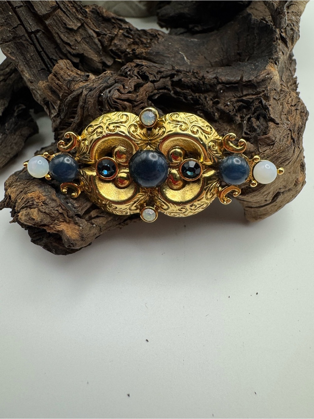 1928 vintage gold tone brooch with blue and milky white accents, EUC.